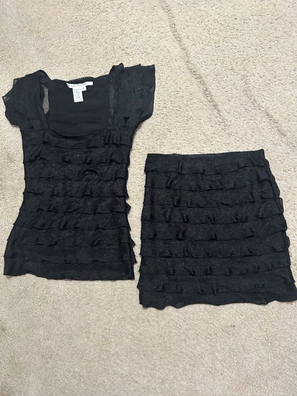 Black textured ruffle top and matching skirt set. (S)